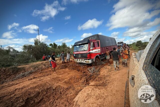 A truck has gotten stuck in the muddy road. A truck has gotten stuck in the muddy road.